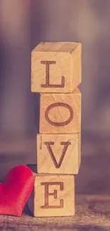 Wooden blocks spelling LOVE with a red heart.