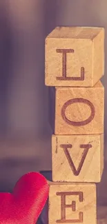 Wooden blocks spelling love with a red heart.