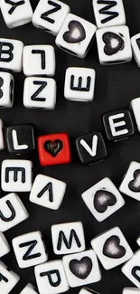 Black and white dice with love letters spelling 'LOVE' on phone wallpaper.