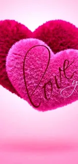 Vibrant pink fluffy heart wallpaper with 'love you' text in elegant script.