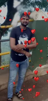 Man standing outdoors with red hearts floating around him.