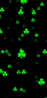 Green clover pattern on a black background wallpaper.