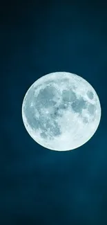 A full moon glowing against a deep blue night sky.