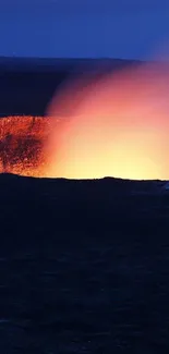 A vivid volcanic eruption lighting up the night sky, showcasing a fiery orange glow.