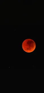 Vivid red moon in a dark starry sky, showcasing a stunning lunar eclipse.