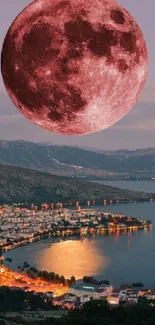 Full moon over a city at night, casting a red glow.