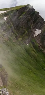 Lush green mountain range with misty slopes.