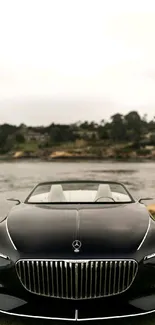 Front view of a luxurious convertible car by the water.