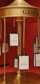 Luxurious Gucci display with gold and shopping bags.