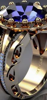 Luxurious gold ring with a blue sapphire gemstone on a gray background.