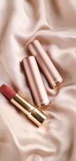 Luxurious satin and elegant lipsticks in a refined arrangement.