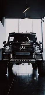 Luxury black SUV in modern showroom interior.