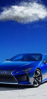 Sleek blue sports car under a vibrant blue sky with clouds.