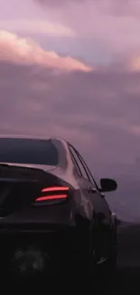 Luxury car driving on road at sunset.