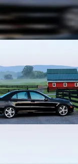 Luxury black car in a peaceful countryside setting with a house.