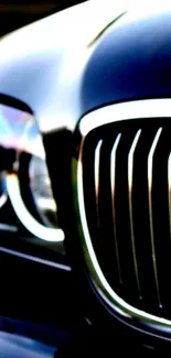 Close-up of luxury car grille and headlight.