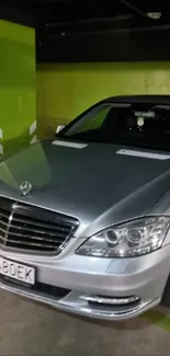 Luxury sedan parked in a green-walled urban garage.