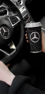 Luxury car interior with a black rhinestone tumbler.