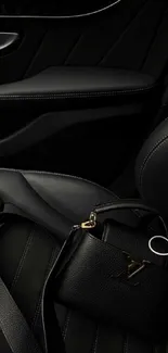 Luxury car interior with black leather seats and handbag.