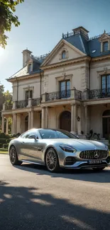 Silver luxury car in front of a grand mansion in sunlight.