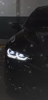 Sleek black car with illuminated headlights at night.