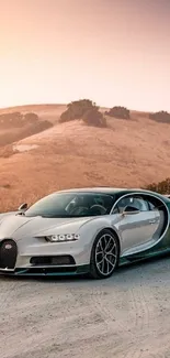 Luxury car parked on a scenic rural road at sunset with hills in the background.