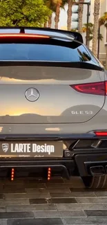 Luxury car rear view at sunset, sleek design.