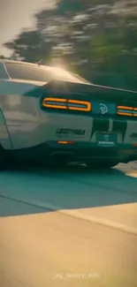 Luxury car speeding at sunset with glowing taillights.