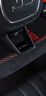 Close-up of a luxury car steering wheel with detailed design.