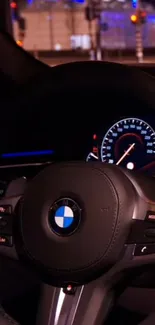 BMW steering wheel against urban lights background