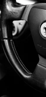 Black and white steering wheel from a luxury car, showcasing elegant design.