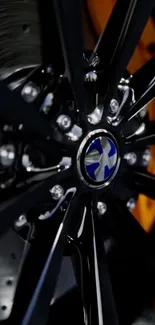 Close-up of luxury car wheel with intricate design and black finish.