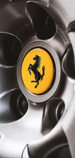 Close-up of a luxury car wheel with vibrant yellow emblem.