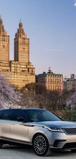 Luxury car in cityscape with cherry blossoms, sunset view.