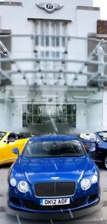 Luxury cars lined up in front of an elegant showroom with a blue car in focus.