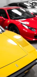 Yellow and red sports cars lined up in a garage.