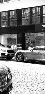 Bentley cars on city street in black and white.