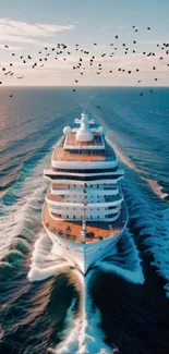 Luxury cruise ship sailing under a sunset sky with birds over the ocean.