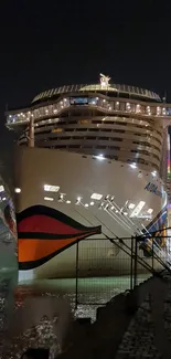 Luxury cruise ship at night in vibrant port lighting.