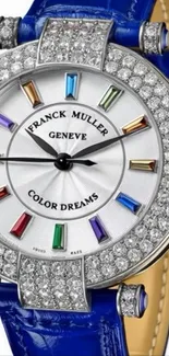 Luxury diamond watch with colorful accents and blue leather strap.