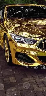 Luxurious golden car in a glossy finish parked on a stone driveway.