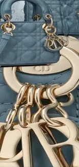Luxury handbag with gold accents on blue quilted background.
