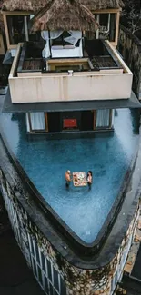 Elevated view of luxury villa with infinity pool.