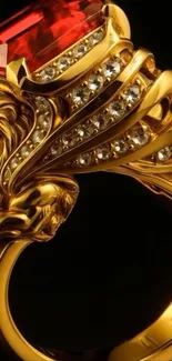 Golden lion ring with red gem and intricate design.