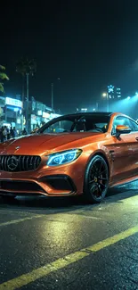 Orange sports car under city lights at night.