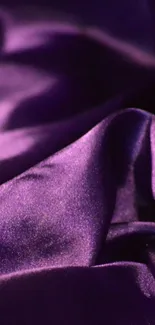 Luxurious purple silk fabric with folds.