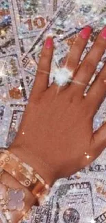 Luxurious hand on glittering dollar bills wallpaper.