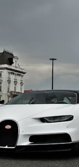 White sports car against city architecture.