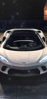 Luxury sports car parked at night with urban background.