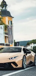 Luxury sports car driving in a scenic urban setting under a cloudy sky.